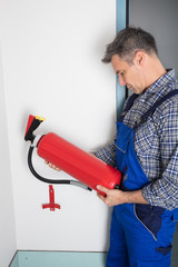 Professional Checking A Fire Extinguisher