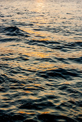 Small waves in the ocean at sunset