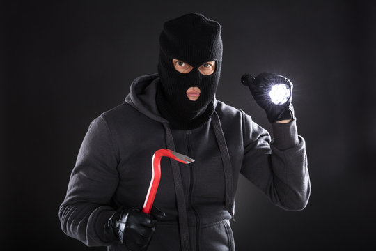 Portrait Of A Burglar On Black Background
