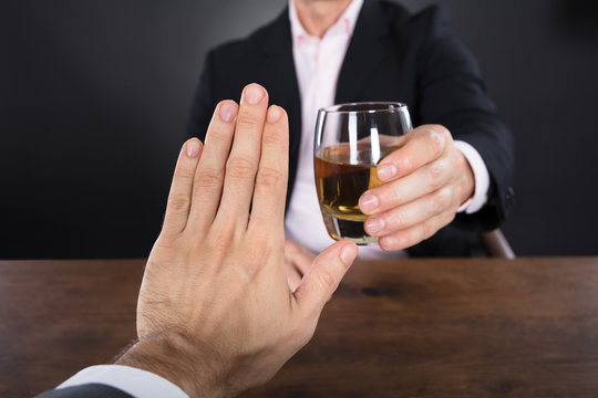Businessman Hand Rejecting A Glass Of Whiskey