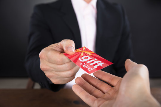 Businessperson Hands Giving Gift Card
