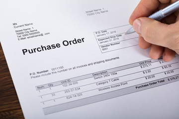 Person Filling A Purchase Order Form