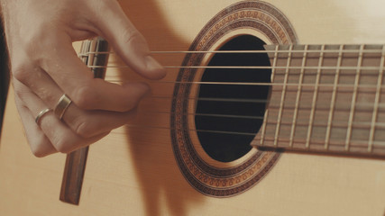 Fototapeta premium Hands of guitarist playing a guitar