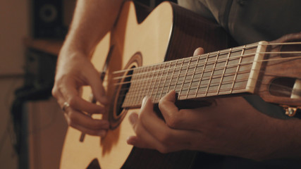 Fototapeta premium Hands of guitarist playing a guitar