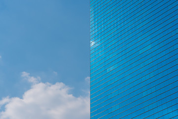 Modern glass building, blue sky with cloud. Background with space for text or logo. Horizontal