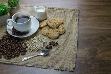 Coffee cup and coffee beans on table