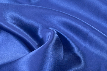 Fototapeta na wymiar Silk background, texture of blue shiny fabric, close up