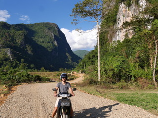 Male motorbike rider in front of forest hill mountain