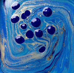 Blue and gold liquid texture. Hand drawn marbling background. Ink marble abstract pattern