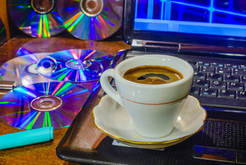 Cup of black coffee, a laptop, CDs, DVDs and flash drives 3