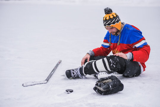 loser hockey player sitting on the ice one