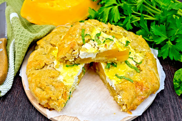 Pie of pumpkin and cheese with parsley on board