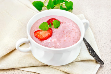 Soup strawberry in white bowl on stone table