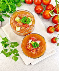 Soup tomato in two glasses on granite table top