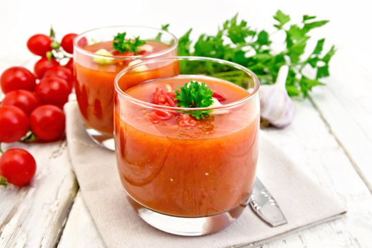 Soup tomato in two glasses on board