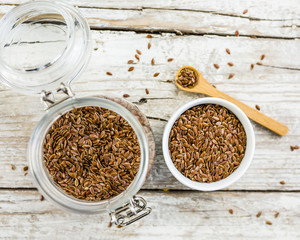 Flaxseed in a jar on a wooden background. Healthy diet and superfood.