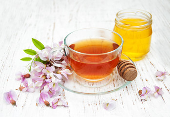 tea and honey with acacia blossoms
