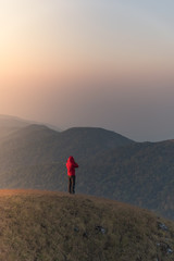 Woman on the top of mountain with sunlight in the morning