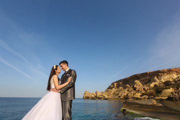 Bride and groom near the sea