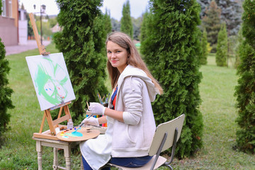 Women beautiful painter posing and smiling, laughing into camera