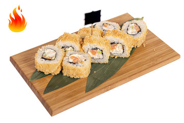 Sushi rolls on wooden Board with leaves of leeks and black sign for logo and name
