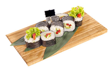 Sushi rolls on wooden Board with leaves of leeks and black sign for logo and name