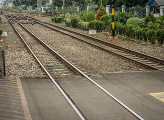 Obraz premium Crossing line for railways with bushes around photo taken in Depok Indonesia