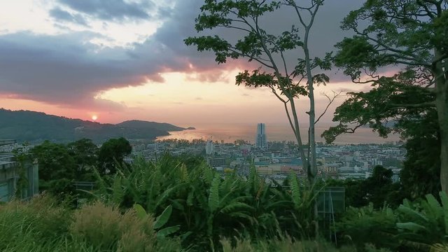 Aerial, 4K Landscape View of Patong Town In Phuket South of Thailand at sunset 