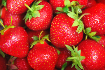 Bright background with fresh strawberries closeup.