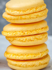 Homemade lemon macaroons on a concrete background.