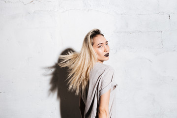 Fototapeta premium Portrait of sensual blonde young woman with black lipstick