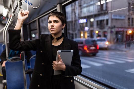 Woman with tablet riding a bus