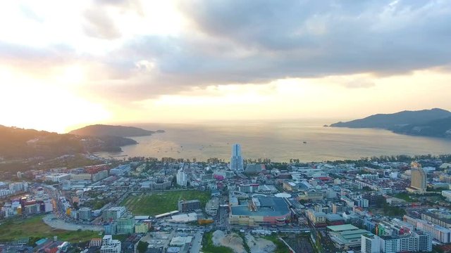 Aerial, 4K Landscape View of Patong Town In Phuket South of Thailand at sunset 