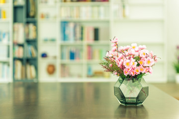 artificial plant with pink flower on the table  in office.