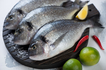 Close-up of raw fresh sea breams ready to be cooked