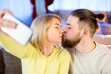 in love young couple in a restaurant makes selfie