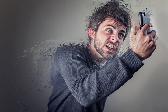 Angry Young Man Screaming At His Cellphone, Disintegrating With Rage