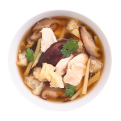 Top view of fish maw soup on white background.