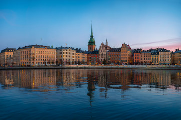 Obraz premium Stockholm old town at morning, colorful sunrise and reflections in water, Gamla Stan, Stockholm, Sweden