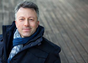 Handsome man. Outdoor winter european male portrait. Attractive confident middle-aged man, city...