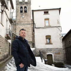 Man in ancient medieval city Broto, Spain. Landscape view of old european town, image toned and...