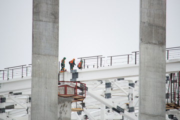 Builders working on the construction of a large building