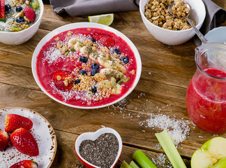 Berry smoothies topped with bananas, blueberries, muesli