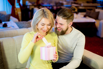 young man gives a gift to the girlfriend
