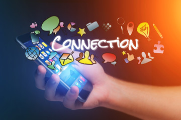 Concept of man holding smartphone with connection title and multimedia icons flying around