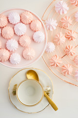 Tea time with pastels colored meringue kisses confectionary