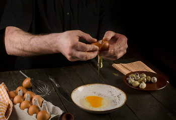 Man hands cracking an egg