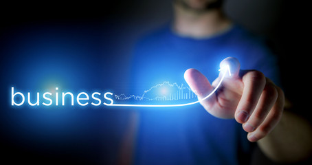 Concept of man touching arrow going up on a technology interface - Business success concept