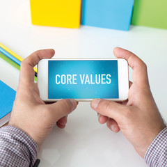 Man holding smartphone which displaying Core Values