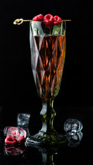 alcoholic cocktail on a dark background with reflection